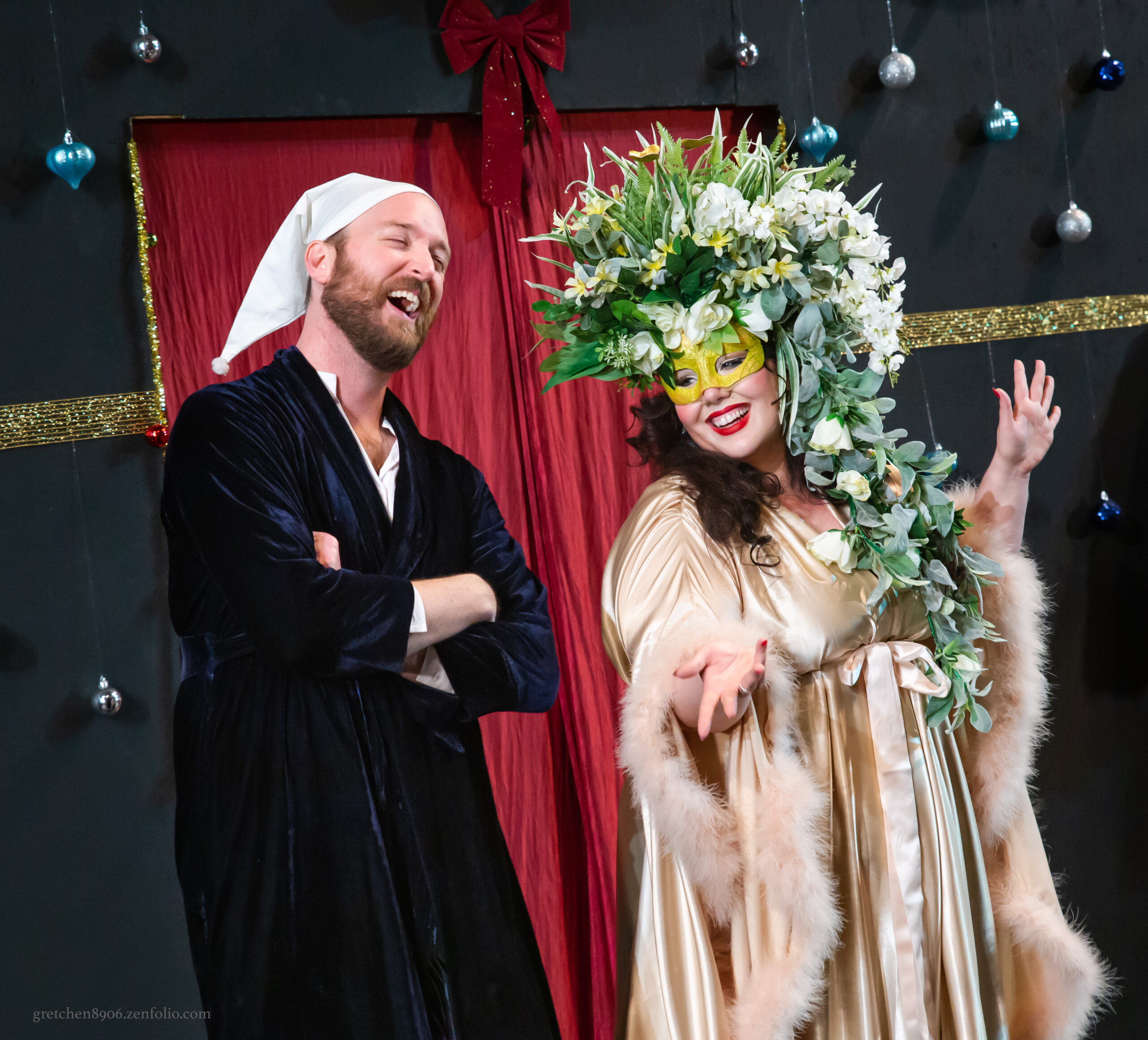 Production photo of A Christmas Carol with two people laughing